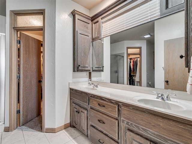 bathroom featuring vanity, tile patterned floors, and walk in shower