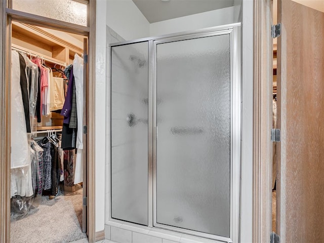 bathroom with a shower with door