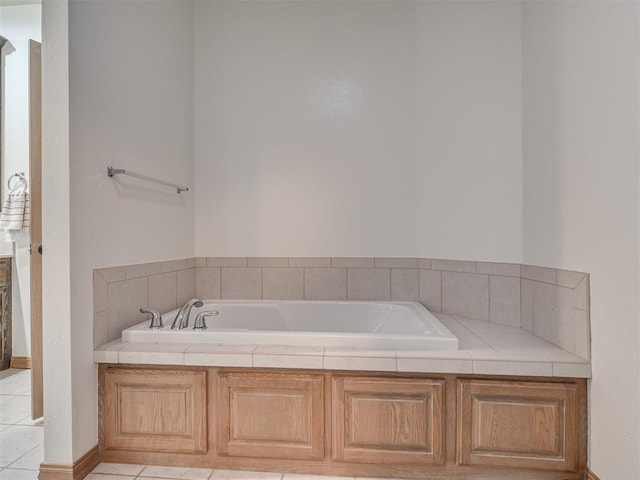 bathroom featuring tile patterned floors and a bath