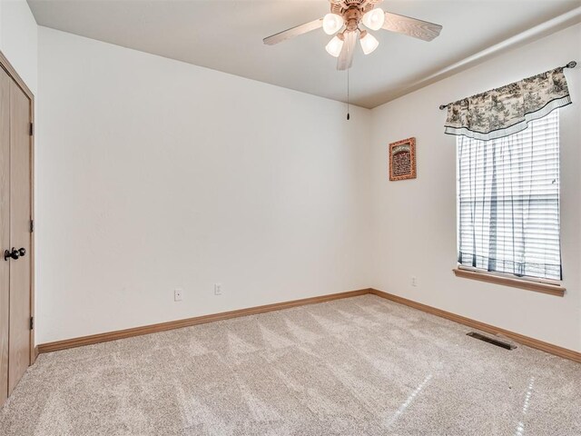 unfurnished room with carpet flooring and ceiling fan