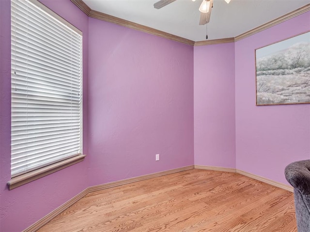 empty room with light hardwood / wood-style flooring and crown molding