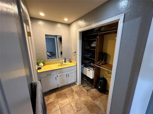 bathroom featuring tile patterned flooring and vanity