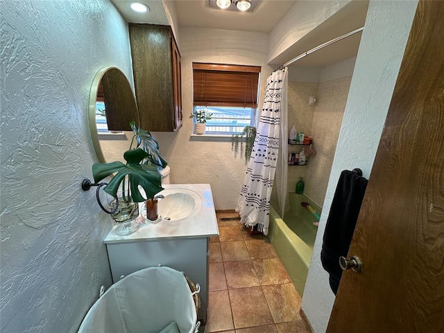 bathroom with shower / bathtub combination with curtain, tile patterned flooring, and vanity