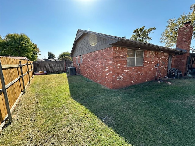 view of home's exterior featuring a yard and central AC unit