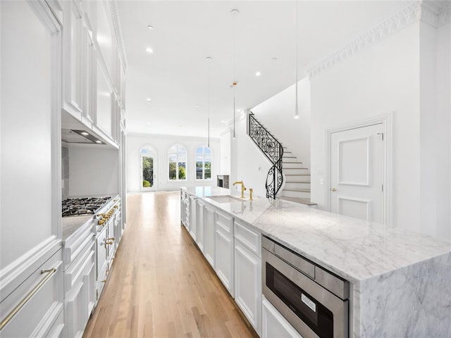 6100 NW Grand Blvd Unit 6105, Oklahoma City, OK 73118 - kitchen with a sink, stainless steel appliances, white cabinetry, a spacious island, and recessed lighting