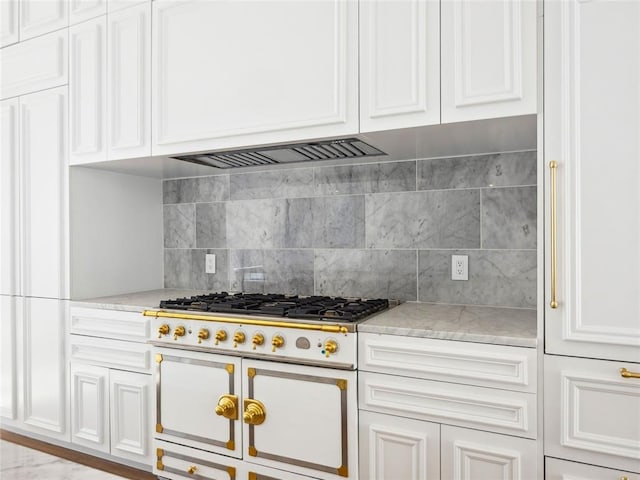 6100 NW Grand Blvd Unit 6105, Oklahoma City, OK 73118 - kitchen with range with two ovens, white cabinets, and tasteful backsplash