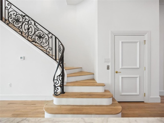 6100 NW Grand Blvd Unit 6105, Oklahoma City, OK 73118 - staircase featuring wood finished floors