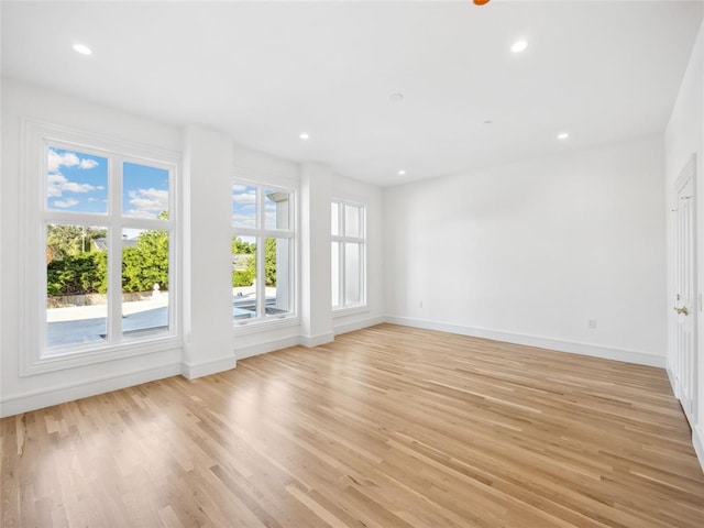 6100 NW Grand Blvd Unit 6105, Oklahoma City, OK 73118 - unfurnished living room with light wood-style floors, baseboards, and recessed lighting