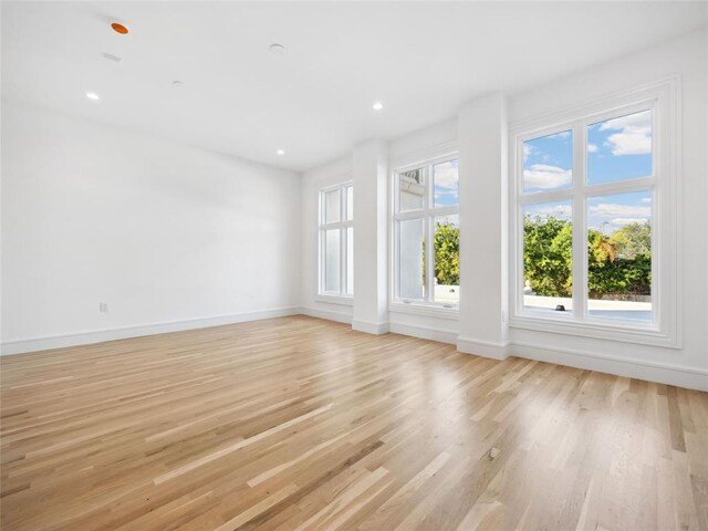 6100 NW Grand Blvd Unit 6105, Oklahoma City, OK 73118 - unfurnished living room featuring light wood-style flooring, baseboards, and recessed lighting