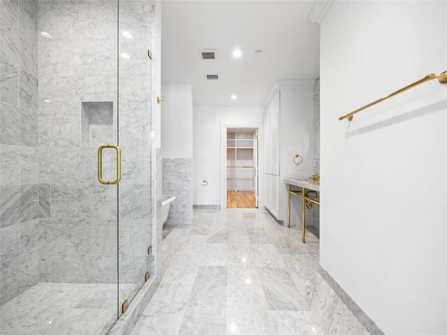 6100 NW Grand Blvd Unit 6105, Oklahoma City, OK 73118 - bathroom with a marble finish shower, a walk in closet, marble tiled flooring, and recessed lighting