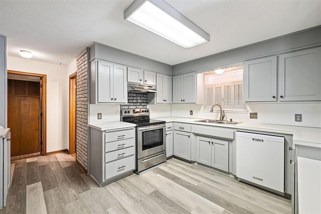 kitchen with a textured ceiling, sink, light hardwood / wood-style flooring, dishwasher, and stainless steel range with electric cooktop