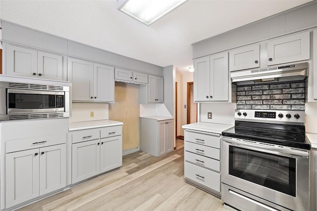 kitchen with stainless steel appliances and light hardwood / wood-style flooring