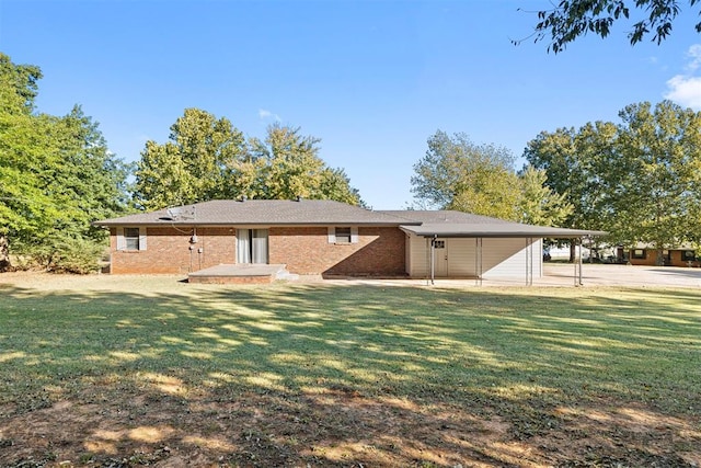 back of property with a yard and a carport