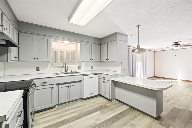 kitchen featuring a textured ceiling, white dishwasher, sink, decorative light fixtures, and black electric range oven