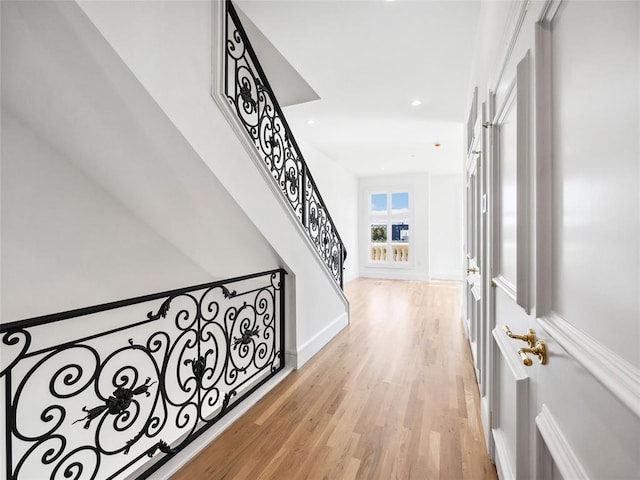 corridor with light hardwood / wood-style floors