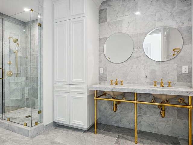 bathroom with a shower with shower door and tile walls