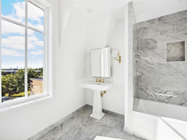 bathroom with a wealth of natural light and tiled shower / bath