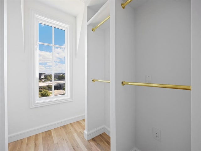 spacious closet with light hardwood / wood-style flooring