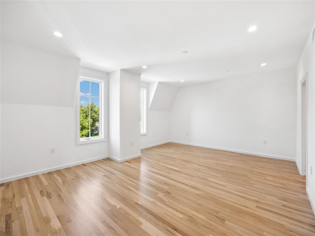 bonus room featuring light hardwood / wood-style floors and vaulted ceiling