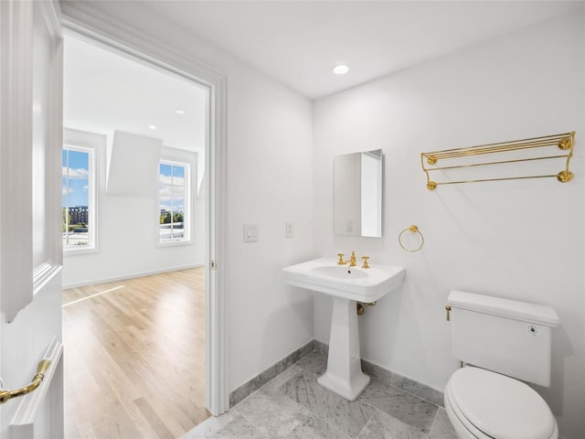 bathroom with hardwood / wood-style floors and toilet