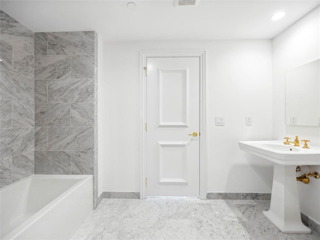 bathroom featuring shower / tub combination and sink