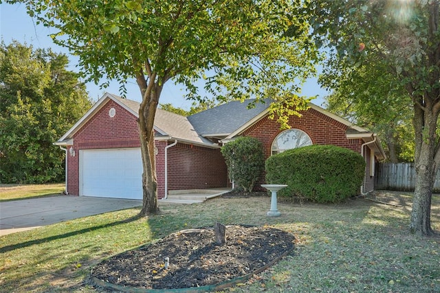 view of front of home featuring a front yard and a garage