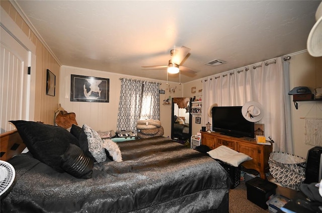 carpeted bedroom with ceiling fan and crown molding