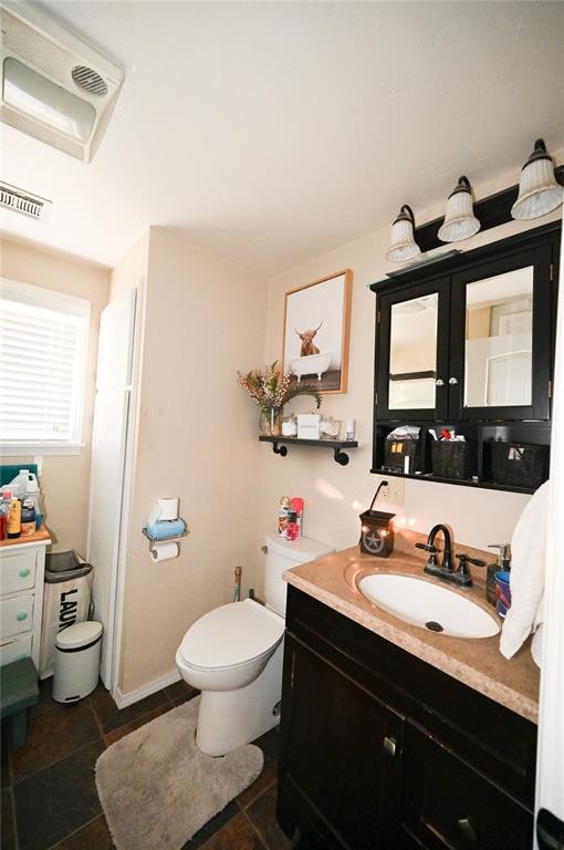 bathroom featuring vanity and toilet