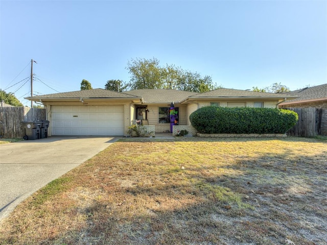 ranch-style house with a garage and a front lawn