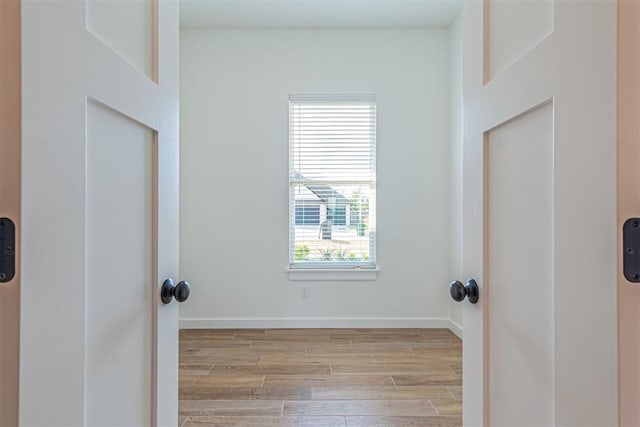 11601 SW 58th St, Mustang, OK 73064 - laundry area with light wood finished floors and baseboards