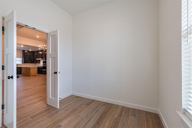 11601 SW 58th St, Mustang, OK 73064 - empty room featuring light wood-style floors, baseboards, a chandelier, and recessed lighting