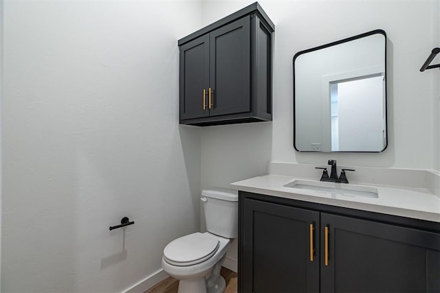 11601 SW 58th St, Mustang, OK 73064 - bathroom featuring vanity, toilet, wood finished floors, and baseboards