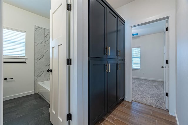 11601 SW 58th St, Mustang, OK 73064 - full bathroom with wood finished floors, baseboards, and shower / bath combination