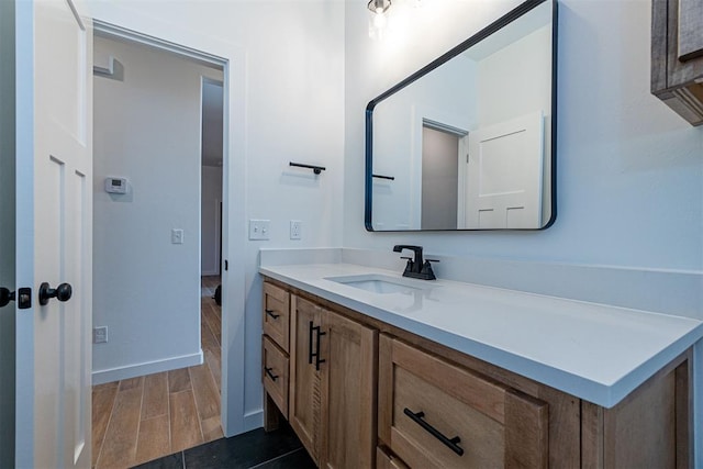 11601 SW 58th St, Mustang, OK 73064 - bathroom with vanity, wood finished floors, and baseboards
