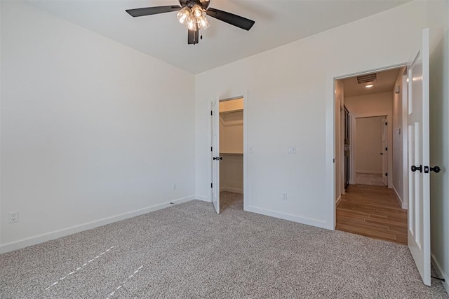 11601 SW 58th St, Mustang, OK 73064 - unfurnished bedroom featuring carpet flooring, baseboards, a walk in closet, attic access, and ceiling fan