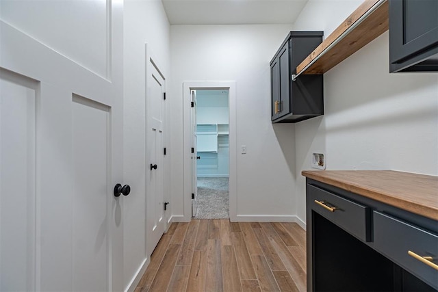 11601 SW 58th St, Mustang, OK 73064 - laundry room featuring cabinet space, light wood-style flooring, baseboards, and washer hookup