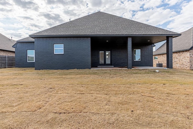 11601 SW 58th St, Mustang, OK 73064 - back of house with brick siding, a shingled roof, and a patio