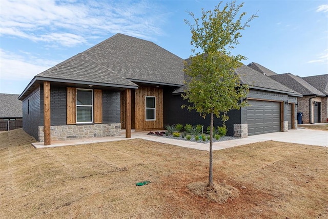 11601 SW 58th St, Mustang, OK 73064 - view of front of property with a shingled roof, a garage, concrete driveway, and brick siding