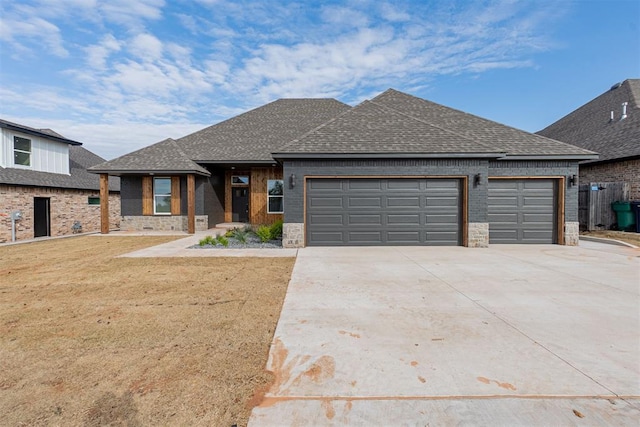 11601 SW 58th St, Mustang, OK 73064 - view of front of house with an attached garage, roof with shingles, concrete driveway, and brick siding