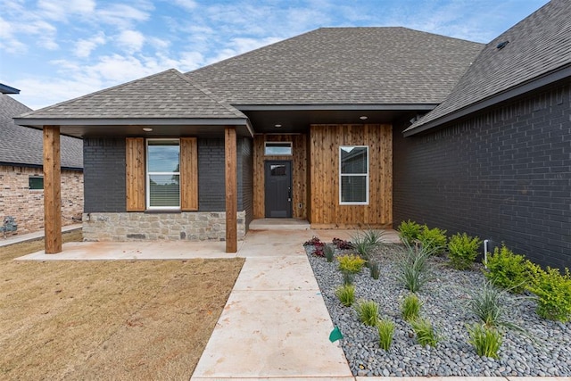 11601 SW 58th St, Mustang, OK 73064 - entrance to property featuring a shingled roof and brick siding