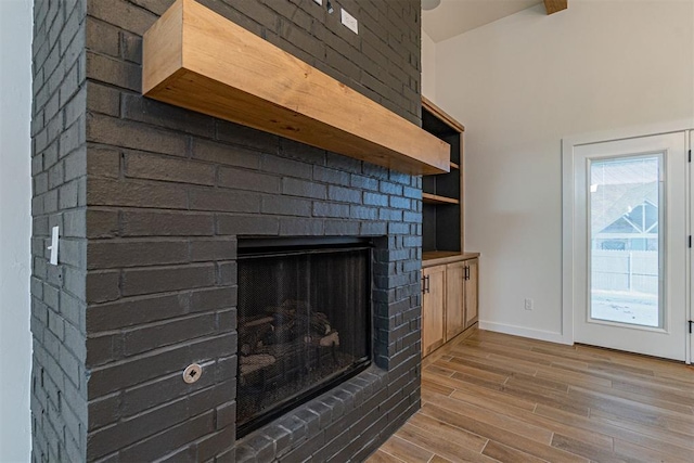 11601 SW 58th St, Mustang, OK 73064 - detailed view of wood finished floors, a fireplace, and baseboards