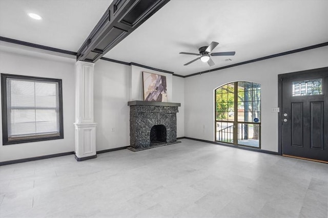 unfurnished living room featuring ornate columns, ceiling fan, and ornamental molding