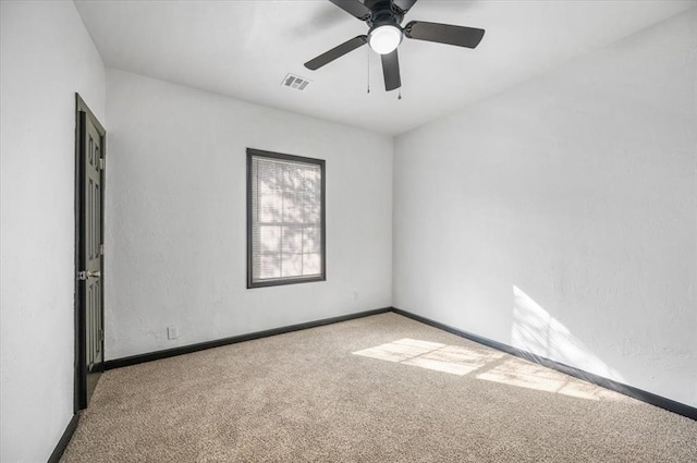 carpeted spare room with ceiling fan