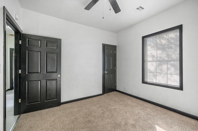 carpeted empty room with ceiling fan