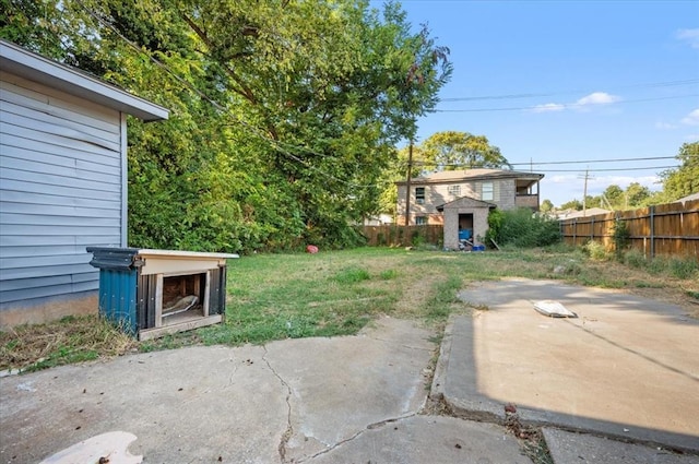 view of yard with a storage unit and a patio