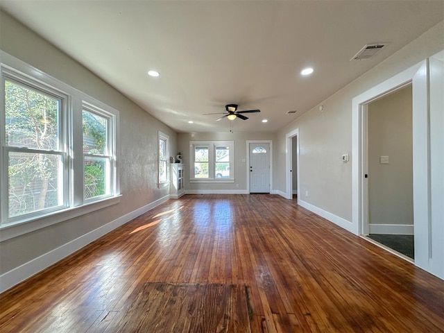 unfurnished living room featuring ceiling fan and wood-type flooring