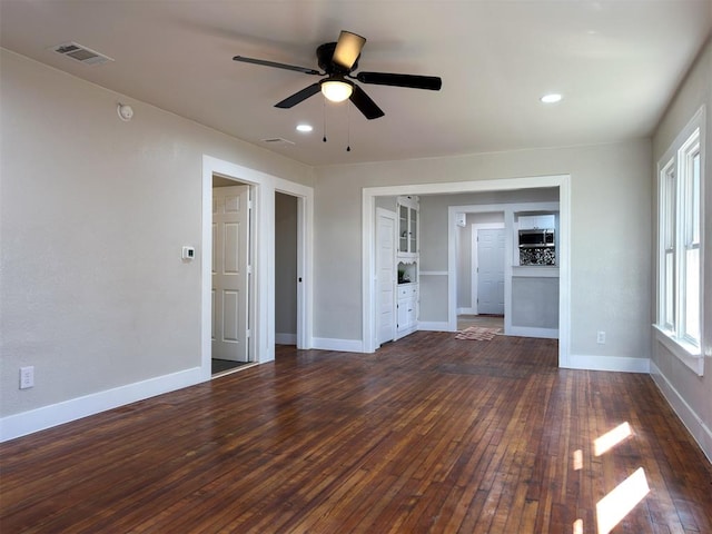 unfurnished living room featuring ceiling fan and dark hardwood / wood-style floors