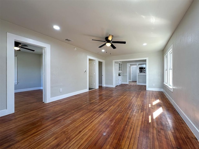 unfurnished living room featuring ceiling fan and dark hardwood / wood-style flooring