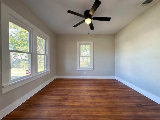 spare room with ceiling fan and dark wood-type flooring