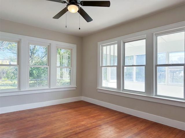 unfurnished room featuring ceiling fan and hardwood / wood-style floors